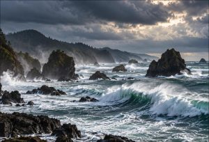 Large winter waves breaking on rocky sea stacks along the Brookings Oregon coast
